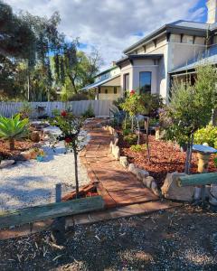 a house with a walkway in front of a yard at Vagabond Historic in Port Germein