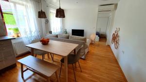 a living room with a table and a couch at Apartma Bovec Center in Bovec