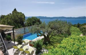 a villa with a swimming pool and a view of the water at Stunning Home In Klek With Jacuzzi in Klek