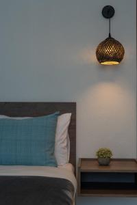 a bedroom with a bed and a pendant light at Hotel Astro in Polykastro