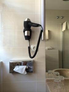 a telephone hanging on a wall in a bathroom at Hotel-Restaurant Walkmühle in Usingen +36 photos