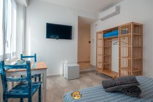 a room with a desk and a bed and a desk and a bedroom at Pesce Palla Affittacamere in Finale Ligure