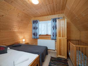 a bedroom with a bed in a wooden cabin at Domki Na Babińcu in Zakopane