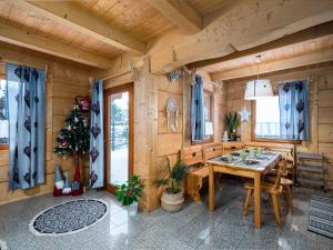 a dining room with a table and a christmas tree at Domki Na Babińcu in Zakopane