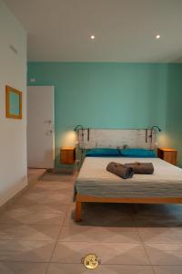 A bed or beds in a room at Pesce Palla Affittacamere