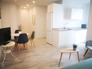 a kitchen and a living room with a table and chairs at Beautiful Apartment in the heart of seville in Seville
