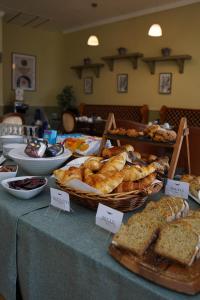 a table with different types of bread and pastries at Alcock & Brown Hotel in Clifden