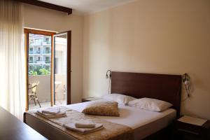 a bedroom with a bed with two towels on it at Apartments MUN Petrovac in Petrovac na Moru +110 photos