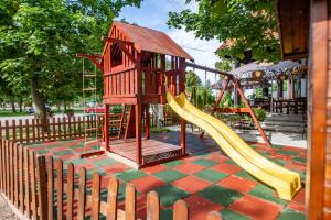a playground with a slide in a park at Penzión Tücsök in Šamorín