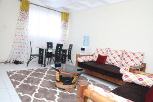 a living room with a couch and a table at Serena Road Villa in Mombasa