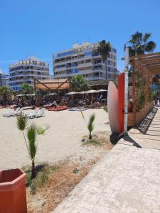 a beach with some palm trees and some buildings at Sea Krystel 603 in Larnaca