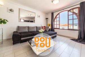 a living room with a couch and a glass table at Apartment Paraiso Royal in Arona