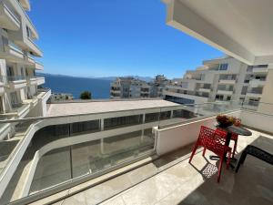 a balcony with a table and a view of the ocean at Luxury Sea View Apartaments in Sarandë