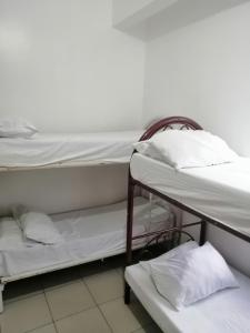 a couple of bunk beds in a room at Two-Hearts Dormitory in Dagupan