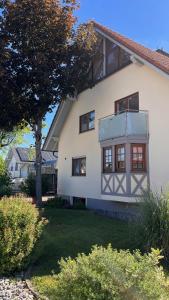 a white house with black windows and a yard at Apartment near Europa-Park & Black Forest in Kappel-Grafenhausen