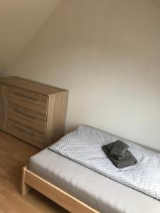 a small bedroom with a bed and a wooden dresser at EZ im Haus Maja in Holzkirchen