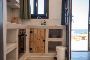a bathroom with a counter with a sink and a toilet at Blue Bliss in Ambrami +128 photos