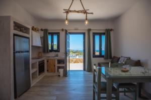 a kitchen with a table and a dining room at Blue Bliss in Ambrami