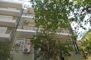 an apartment building with balconies and trees at Albion in Athens