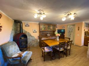 a living room with a table and a wood stove at La Nicchia di Franco in Montignoso