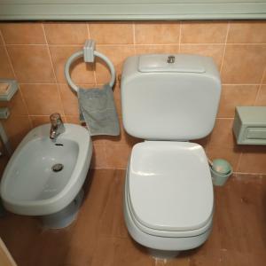 a bathroom with a toilet and a sink at La Nicchia di Franco in Montignoso +42 photos