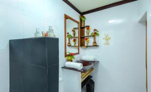 a bathroom with a sink and a mirror at Maladiwa Beach & Spa in Maafushi