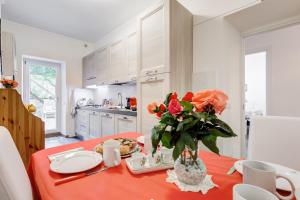 une cuisine avec une table et un vase de fleurs. dans l'établissement Alloggio turistico Giuly ID 3807, à Monte Porzio Catone