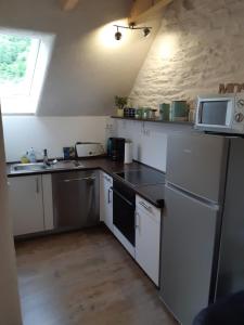 a small kitchen with a sink and a microwave at Ferienwohnung Fritzer in Ellenz-Poltersdorf +13 photos
