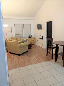 a living room with a couch and a table at HISTORIC HILL APARTMENTS (Duplex) in Tuskegee