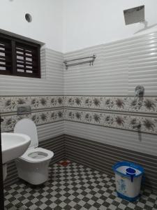 La salle de bains est pourvue de toilettes et d'un lavabo. dans l'établissement The Camp Club Beach Villa, à Payyannūr