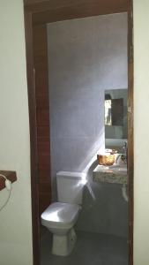 a bathroom with a white toilet and a sink at Casa Antiga Hospedagem - Taipu de Fora in Barra Grande +20 photos