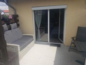 a living room with a couch and a sliding glass door at Ferienwohnung Luna in Stralsund