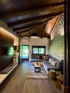 a living room with a couch and a table at Bocca al Lupo Villas in Kato Loutraki