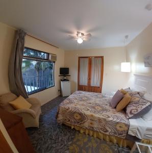 a bedroom with a large bed and a window at Vista Canyon Inn in Santa Ana