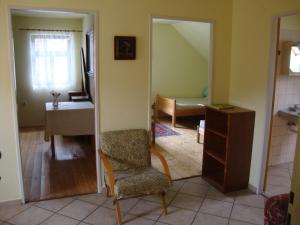 a living room with a chair and a table at Petrovický mlýn in Kasanice