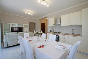 a kitchen and dining room with a table and chairs at Palazzo Richard Leone in Udine