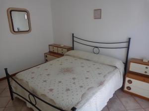 a small bedroom with a bed and a mirror at San Gabriele Arcangelo in Porto SantʼElpidio