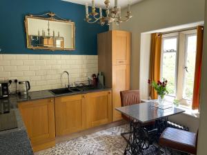 a kitchen with a sink and a table at The Lodge in Cressbrook