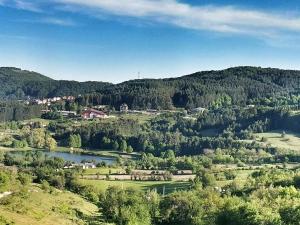 een uitzicht op een vallei met een rivier en bomen bij The Mountain House Doris in Kruševo