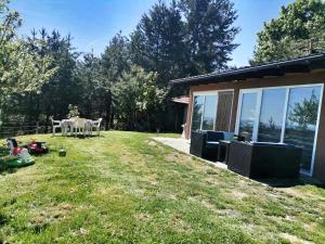 a backyard of a house with a table and chairs at The Mountain House Doris in Kruševo