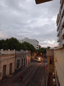 a city street with a train on the tracks at Hotel Dinastia Boutique in Salta