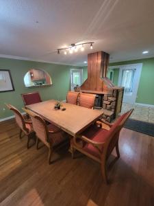 a dining room with a wooden table and a stove at 6 King beds and More, Chic Cordova Near Shopping in Memphis