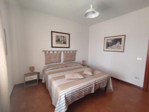 a bedroom with a bed and a table in it at Sole&Luna in San Teodoro