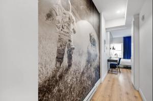 a hallway with a wall mural of a baseball player at INITIAL - ASTRONAUTE - Centre-Ville de Quebec in Quebec City