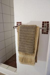 a towel hanging on a towel rack in a bathroom at Olive Branch El Chorro in El Chorro