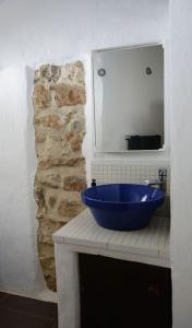 a blue bowl on a counter in a bathroom at Olive Branch El Chorro in El Chorro
