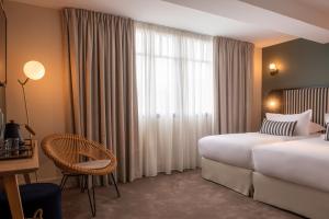 Cama ou camas em um quarto em Le Celtique & Spa