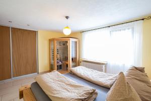 a living room with two beds and a window at FEWO zum gscheiten Beck mit grosser Terrasse in Feldberg