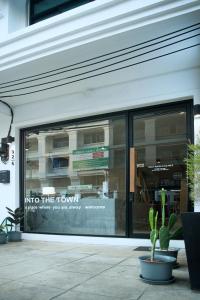 a store front window with a sign into the tours at Into the town krabi in Krabi