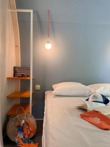 a bedroom with a bed and a book shelf at Camping Club l'Air Marin in Vias